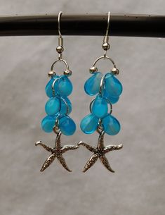 Let the spirit of the tropics surround you as you wear these earrings! The blue tear drop glass beads represent the ocean water. The pewter star fish adds the finishing touch French ear wire is silver plated. Ocean-inspired Starfish Charm Earrings, Beach Teardrop Jewelry With Dangling Beads, Beach Jewelry With Teardrop Dangling Beads, Teardrop Dangling Beads Jewelry For Beach, Nickel-free Starfish Earrings Ocean-inspired, Beach Dangle Teardrop Earrings With Ear Wire, Czech Glass Drop Earrings For Beach, Ocean-inspired Drop Earrings With Starfish Charm, Ocean-inspired Starfish Charm Dangle Earrings