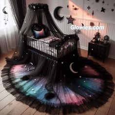 a baby crib with stars and moon decorations on it