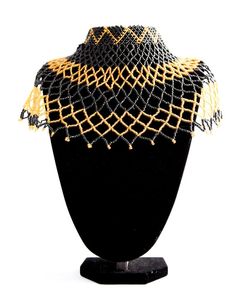 Big black and gold African beaded tribal chest piece choker statement necklace.One-of-a-kind and handmade by the Maasai Tribe in Kenya.Made from black and gold Maasai beads.Measuring approximately 54 cm across and 19 cm long.The choker top measures 27 cm with a beaded clasp, adding up to an additional 5 cm with the 2 different adjustable sizes.A serious statement piece.Fit for an Empress. Black Beads With Gold Details For Festival, Black And Gold Beads For Festival, Black Beaded Necklaces With Gold Beads For Festival, Traditional Black Choker With Colorful Beads, Bohemian Black Beads Choker, Black Bohemian Bead Choker, Bohemian Black Bead Choker, Unique Black Beaded Choker, Black Round Beads With Bead Caps