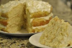 a piece of cake sitting on top of a white plate next to a slice of cake