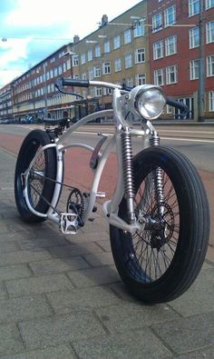 a white motorcycle parked on the side of a road