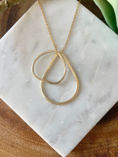 "Looking for a simple, but beautiful geometric necklace that is great for layering? Here it is! This handmade necklace is made from a triangular shaped charm and a teardrop shaped charm strung through a delicate chain. The photos show this necklace at 24\", but custom lengths are always welcome! This unique necklace is perfect for anyone loves accessorizing with on trend, modern or minimalist jewelry. Made from high quality 16k gold plated brass. It has an effortless chic vibe to it and is great Delicate Chain Teardrop Necklace For Layering, Teardrop Delicate Chain Necklace For Layering, Dainty Teardrop Pendant Necklace For Layering, Dainty Teardrop Necklace For Layering, Modern Teardrop Pendant Necklace With Adjustable Chain, Minimalist Drop Necklace For Layering, Gold Minimalist Necklace With Teardrop Pendant, Everyday Teardrop Chain Necklace With Adjustable Chain, Gold Minimalist Teardrop Pendant Necklace