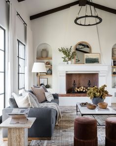 a living room filled with furniture and a fire place