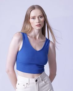 Flaunt your curves in this sultry and slim-fitting V-neck crop top! Crafted from a high stretch rib-knit fabric with a blend of 97% polyester and 3% spandex, this casual and comfortable piece is ideal for any occasion. Machine wash or professionally dry-clean for effortless care. Trendy Seamless V-neck Crop Top, Trendy Solid V-neck Crop Top, Seamless V-neck Top For Summer, Ribbed V-neck Elastane Top, Chic Fitted V-neck Crop Top, Trendy V-neck Bra Friendly Tops, Stretch Ribbed V-neck Tank Top, Chic Stretch Low-cut Crop Top, Chic Low-cut Stretch Crop Top