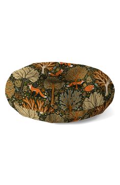 a round tray with an orange fox and leaves pattern on the front, sitting on a white surface