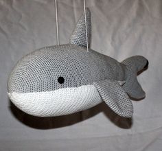 a stuffed toy whale hanging from a string