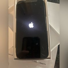 an apple phone is in the box with its lid open and it's brand new