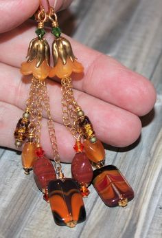 Gorgeous art glass earrings with new Czech feathered glass beads, vintage art glass beads, acrylic pale orange flower beads, vintage gold leaf bead caps, and gold plated lever backs. Measures 4" long & .5" wide. As shown in the last photo I have matching jewelry pieces available in my Etsy Shop: https://www.etsy.com/shop/JesseGoldenJewels?ref=seller-platform-mcnav&search_query=B234 Your purchase will be carefully packaged for shipping. Will ship USPS First Class next day after payment, excluding Gold Beaded Glass Earrings, Orange Beaded Vintage Earrings, Vintage Orange Beaded Earrings, Gold Glass Earrings With Dangling Beads, Vintage Gold Glass Earrings, Vintage Orange Czech Glass Earrings, Vintage Orange Earrings With Czech Glass, Vintage Gold Beaded Earrings With Dangling Beads, Vintage Czech Glass Earrings With Dangling Beads