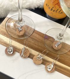 four wine glasses sitting next to each other on a counter top with corks in them