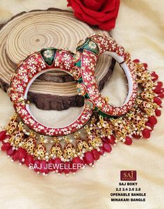 Its unique craftsmanship with fine red and green meenakari detailed with pearls and Kundan makes it look more royal, ethnic, and traditional. This pair of bangles will surely add elegance & spark to the entire look. All sizes are available. Perfect choice for weddings, parties, and other Indian festivals. Keep it in Zip Locks or Plastic Boxes. Keep the jewelry away from heat, water, sprays, and chemicals as they may react. The images represent the actual product though color and image may slight Bridal Bangles Set, Meenakari Bangles, Bangles For Women, Bangles Set, Bridal Bangles, Indian Festivals, Bangle Set, Red Green, Bangle Bracelets