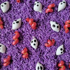 purple rice with halloween decorations on it and ghost heads in the middle, all over