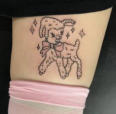 a small teddy bear tattoo on the thigh