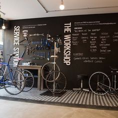 two bikes are parked in front of a blackboard with words on it that read the workshop