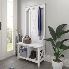 a white bench sitting next to a potted plant