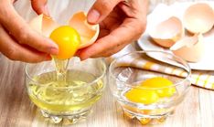 someone is squeezing an egg into a small glass bowl on a table with eggs in it