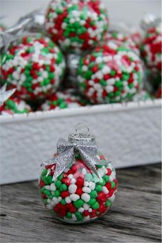 christmas baubles in a white box on a wooden table