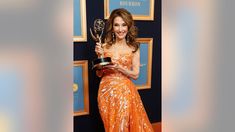 the actress poses with her award for outstanding performance in a supporting role on tv series