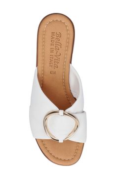 A shiny buckle decorates the supple leather straps at the vamp of this comfy-chic slide sandal set on a stacked heel. 2" heel Cushioned footbed Leather upper/leather and synthetic lining/synthetic sole Made in Italy Elegant Leather Slides With Buckle Closure, White Leather Slide Sandals, White Summer Slides With Buckle Closure, White Flat Slides With Buckle Closure, White Slip-on Slides With Buckle Closure, The Vamp, Comfy Chic, Fashion Spring, Sandal Women