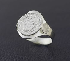 This Beautiful and Traditional Saint Benedict is made from high-quality Sterling Silver 925 Its the perfect gift for anyone of any age and excellent for everyday wear. Item Specifications: Model # PAS2 Metal Type: Sterling Silver Metal Stamp: 925 Shape St. Benedict Style: Traditional Ring Front : 14mm (9/16 inch) Size: 6, 7, 8, 9, 10 Stones: No All jewelry comes in a gift box We will ship within 1-2 business days by USPS, Please make sure your address is correct As we mention customer service is Nickel-free White Gold Signet Ring For Anniversary, Classic Sterling Silver Engraved Ring, Nickel Free, Classic Sterling Silver Engraved Ring Nickel-free, Classic White Gold Rings For Commemoration, Classic Sterling Silver Signet Ring For Commemoration, Adjustable Silver Rings For Commemoration, Sterling Silver Commemoration Rings, Sterling Silver Commemorative Round Rings, Classic Sterling Silver Rings For Commemoration