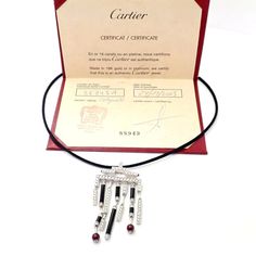 Metal: 18k White Gold  Measurements: Length silk cord: 17.25''  Pendant: 33mm x 62mm  Weight: 24.5 grams  Stones: 153 round brilliant diamonds, E color, VVS1 clarity total weigh approximately 3ct. Also with 6 onyx stones, and 2 ruby beads 6mm each.  Hallmarks: Cartier 750 (serial number omitted) French Hallmarks   Please read description for most accurate dimensions and use QA to inquire on any additional details. Cartier Silver Jewelry With 17 Jewels, Cartier Black Evening Jewelry, Luxury Cartier Jewelry For Evening, Designer Black Necklace As A Gift, Designer Black Necklace For Gift, Designer Black Necklaces For Gift, Cartier Designer Diamond Jewelry, Designer Diamond Cartier Jewelry, Designer Cartier Diamond Jewelry