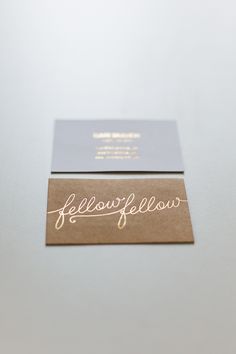 two business cards sitting on top of each other with the words fellow fellow written on them