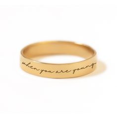 Have your favorite Taylor Swift quote engraved on a classic band ring. Gold Filled Hypoallergenic, lead and nickel free Band Width 3.5mm Customize your message, maximum of 60 characters (including spaces). In photo: "Life is tough my darling, but so are you" - Maya Angelou #R015-G Meaningful Engraved Promise Ring With Engraving Option, Meaningful Promise Ring With Engraving Option, Meaningful Engraved Ring For Promise, Adjustable Engraved Ring With Text For Promise, Minimalist Engraved Ring For Promise, Adjustable Engraved Ring With Round Band, Taylor Swift Quote, Engraved Ring, Gold Bond