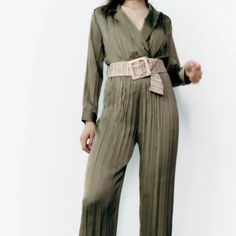 Creased Jumpsuit With A Lapel Collar V-Neckline And Long Sleeves Contrast Belt And Elastic Waistband. Straight-Leg Design. New With Tag Color : Olive Green Chic Green V-neck Jumpsuit, High Waist Belted Jumpsuits For Workwear, Belted V-neck Jumpsuit For Night Out, Chic Belted Green Jumpsuits And Rompers, Chic Green Belted Jumpsuits And Rompers, Chic Green Belted Jumpsuit, Green V-neck Jumpsuit For Work, Green Belted Jumpsuits And Rompers For Work, Casual Long Sleeve Pantsuit For Party