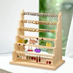 a wooden jewelry rack with earrings on it