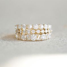 a stack of gold rings with pearls and diamonds