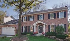 a large brick house with black shutters