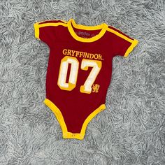 - Harry Potter - Baby - Gryffindor Onsie - Short Sleeves - Red And Yellow - Size: 12 Months - New Without Tags - Purchased From The Nyc Store Red Short Sleeve Cotton Bodysuit, Red Cotton Short Sleeve Bodysuit, Cute Fitted Red Onesie, Cute Red Fitted Onesie, Cute Red Short Sleeve Bodysuit, Cute Red Fitted Bodysuit, Cute Fitted Red Bodysuit, Red Fitted Cotton Bodysuit, Red Short Sleeve Onesie For Playtime