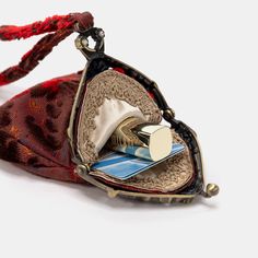 Introducing our exquisite Chatelaine Small Wristlet Purse, designed for those seeking a compact and stylish accessory.With a frame width of 3.15" and a height of 5", this small purse offers a charming and minimalist silhouette. Please note that the storage space is limited due to the unique shape of the frame.Inside the purse, you'll find a small pocket with a bottom width of 1", providing a convenient space for storing keys, coins, or lipsticks. The accompanying 6" wristlet strap is crafted from the same fabric as the body, adding a touch of elegance to this compact purse.Please be aware that the Chatelaine Small Wristlet Purse is designed to hold small items only and cannot accommodate a phone or passport. It is perfect for those occasions when you need to carry just the essentials in a Portable Handheld Pouch For Gifts, Victorian Pouch Bag For Gift, Gold Coin Purse With Coin Pocket As A Gift, Victorian Style Pouch Bag For Gift, Victorian Pouch Bags As Gifts, Victorian Style Pouch Bag As Gift, Gold Coin Purse As Gift, Handheld Coin Purse As Gift, Elegant Clutch With Card Slots For Gift