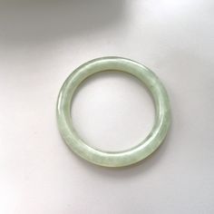 On offer is this beautiful Vintage Chinese 1960's Hand Carved Translucent Celadon Green Nephrite Jade Bangle featuring tiny emerald green color veins within the Nephrite Jade which can be seen because the Nephrite is so transparent. Genuine undyed Nephrite Jade which is 10 mm wide and has 7.514 inches inner circumference. In very good vintage condition with no damage or repairs because it is old stock that has never been worn.  Weight 39.2 grams. The Nephrite Jade has achieved a lovely pearly ag Classic Green Jade Jewelry, Classic Jade Bracelets For Formal Occasions, Green Bangle Bracelet For Formal Occasions, Green Bangle Bracelets For Formal Occasions, Formal Green Bangle Bracelets, Green Classic Bangle For Formal Occasions, Elegant Green Round Bangle, Classic Jade Bracelet Jewelry, Classic Jade Bracelet