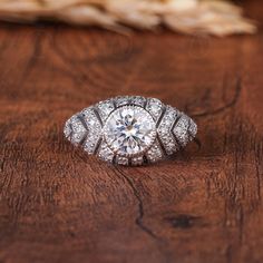 a diamond ring sitting on top of a wooden table