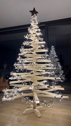 a christmas tree made out of wooden planks with lights on the top and bottom