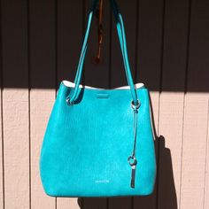 Brand New 13" H X 14" W X 6" D Beautiful Turquoise Bag, Comes With Dust Cover. 29 " Double Handles. Blue Double Handle Bucket Bag For Errands, Blue Bucket Bag With Detachable Handle For Errands, Blue Bucket Satchel For Shopping, Calvin Klein Rectangular Bags With Silver-tone Hardware, Blue Bucket Satchel With Detachable Handle, Blue Satchel Bucket Bag For Errands, Blue Bucket Bags For Errands, Blue Shoulder Bucket Bag For Errands, Blue Satchel Bucket Bag For On-the-go