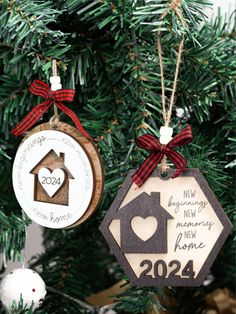 two ornaments hanging from a christmas tree in the shape of a house and a doghouse