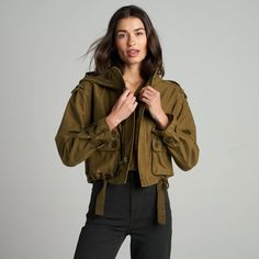 The Finnian is a showstopper, our take on a military-inspired utility coat with a high funnel neck and deep hood made from 100% Japanese sateen cotton. With an oversized yet cropped cut, it’s feminine with lots of attitude. Military details abound such as functional epaulets at the shoulders, three-dimensional patch po Military Jacket Outfits, Trapunto Quilting, Cotton Gauze Shirt, Gauze Shirt, Raglan Hoodie, Maxi Knit Dress, Military Inspired, 2024 Fashion, Cut It