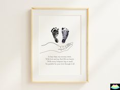 a hand holding a baby's foot with a poem below it on the wall