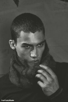 a man with a goatee and scarf on his head is posing for a black and white photo