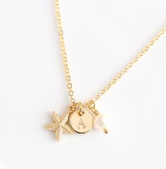 Personalized tiny Gold Starfish Necklace, Initial Necklace, 18K Gold Plated, Star fish charm necklace, Beach Jewelry pendant Mothers Day This elegant Necklace is a unique piece. Get a chance to have your Necklace engraved with your first name letter in the font of your choice. This is the perfect gift for Mothers Day, Grandmother, best friends, Bridesmaids...  Made with: - 26 inches or 66 cm 18K gold plated Chain - 18K gold-plated starfish 10 mm or .39 inches - 5 mm or .19 inches Fresh Water Pearl  - Personalized 18K gold plated disc 0.31 inches or  8 mm - Size: 26 inches or 66 cm - Can shorten it on demand. - It will come in a lovely jewelry box. This model is 100% handmade and is lead-free. You may also like Poodle Balloon Dog Gold Necklace https://www.etsy.com/listing/493535942/poodle-b Gold Starfish Charm Necklace, Dainty Gold Starfish Charm Necklace, Gold Charm Necklace With Starfish Charm, Gold Starfish Charm Necklace Gift, Starfish Charm Pendant Necklace For Gift, Starfish Charm Pendant Necklace Gift, Star Charm Initial Pendant Necklace As Gift, Gift Starfish Charm Pendant Necklace, Starfish Charm Necklaces As Gift