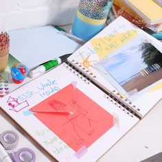 an assortment of children's artwork and crafts on a table