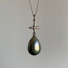 Shades of green and gray cascade subtly down this ombre Tahitian pearl. 18k white gold Tahitian pearl 7/16" x 5/8" Diamond accent Chain is 18" long Tahitian Pearl Pendant, Star Cross, Green And Gray, Newport Ri, Tahitian Pearls, Gold Cross, Wood Earrings, Pearl Pendant, Shades Of Green