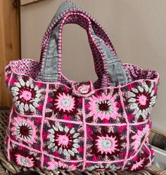 a crocheted purse sitting on top of a wicker basket