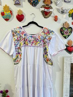 Our San Antonino dresses are unique, beautiful and perfect for any fiesta, a day at the beach or a formal event. You can easily dress it up or dress it down. Our dresses are completely hand embroidered by Artisans in Oaxaca, Mexico. It takes approximately 1 month to complete one dress.  Our San Antonino dresses are one of a kind. You will fall in love with every single detail. Each dress is hand embroidered on front chest area, sides and back with tiny floral designs inspired by the flowers in the region using beautiful color combinations. Crochet on sleeve and neckline. Across the chest, it has the "Hazme Si Puedes" (Make Me if You Can) technique, distinctive to their community. This intricate crochet technique shows tiny men and women lined together holding hands.  -Fabric & thread are 1 Embroidered Short Sleeve Dress For Garden Party, Embroidered Short Sleeve Midi Dress For Garden Party, Short Sleeve Embroidered Midi Dress For Garden Party, Embroidered Midi Dress With Short Sleeves For Garden Party, Floral Print Short Sleeve Embroidered Dress For Garden Party, Short Sleeve Embroidered Floral Dress For Garden Party, Short Sleeve Floral Embroidered Dress For Garden Party, Summer Dresses With Intricate Embroidery And Short Sleeves, Embroidered Multicolor Dresses For Garden Party