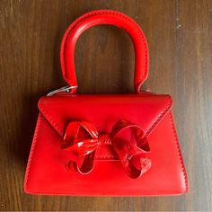 From Self-Portrait, Mini Top Handle Bag In Smooth Red Leather With Metal Bow Detail. Includes Shoulder Strap, Dust Bag, And Box. New And Never Used. H: 3.5” (7” With Handle) L: 5.5” At Base W: 2” At Base Designer Satchel Evening Bag As Gift, Luxury Red Satchel Evening Bag, Red Clutch Evening Bag With Detachable Handle, Red Clutch Evening Bag For Shopping, Red Leather Top Handle Evening Bag, Luxury Red Evening Bag With Removable Pouch, Red Evening Clutch With Detachable Handle, Red Shoulder Bag With Detachable Handle For Evening, Red Clutch Evening Bag With Detachable Strap