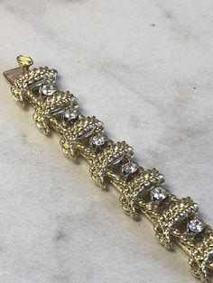 "18kt Yellow Gold Heavy Solid Lady's Cubic Zirconia (CZ) Bracelet 7\" in Length. This Bracelet consists of 18- 3mm, .10ct each , 1.80ctw Cubic Zirconia (CZ) all prong set in 14kt White Gold settings in a heavy solid 12mm wide hinged mounting. There is a hidden box clasp with a secure fig 8 safety clasp. These CZ's look so real. Total mounting weigh is 43.8 grams. This item would Retail for $6,550.00" Dazzling Diamond Bracelet With 17 Jewels For Anniversary, Dazzling Gold Diamond Bracelet For Anniversary, Gold Tennis Bracelet With Single Cut Diamonds For Wedding, Gold Diamond Bracelet With 17 Jewels For Anniversary, Diamond Crystal Bracelet With Prong Setting For Anniversary, Dazzling Gold Bracelet With Diamond Accents For Formal Occasions, Gold Diamond Bracelet With Sparkling Stones For Formal Occasions, Formal Gold Bracelet With Sparkling Cubic Zirconia, Dazzling Cubic Zirconia Gold Bracelet For Anniversary