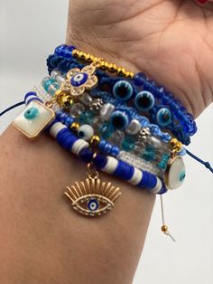 Arm candy anyone? Yes, this has an assortment of evil eyes that she can wear stackable or one at a time. Some will be threaded, some have faceted beads, some have Heishi beads, and some wooden beads. Combination looks great together, but can be sold individually. Great to wear for protection. Bohemian Blue Braided Bracelet With Evil Eye, Trendy Evil Eye Beaded Bracelets For Festivals, Bohemian Evil Eye Beaded Bracelets For Jewelry Making, Bohemian Beaded Evil Eye Bracelets For Jewelry Making, Bohemian Beaded Bracelets For Jewelry Making With Evil Eye, Trendy Blue Bracelets With Evil Eye, Trendy Blue Evil Eye Bracelets, Trendy Evil Eye Bracelet For Festivals, Energy Stones Crystal Healing