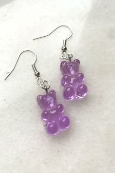 Cute and sweet gummy bear earrings. Not only for Haribo bears lovers. Full of colors A pair of plastic gummy bear earrings available in blue, yellow, pink, purple, red, orange or transparent. Very lightweight and perfect for both adults and kids. Different colors to show all styles and express every personality. #gummybear #gummybearearrings #pinkearrings #orangeearrings #funnyearrings #sweetearrings Cheap Fun Festival Earrings, Gummy Bears Earrings, Weird Earing, Gummy Bear Outfit, Cute Hypoallergenic Clear Jewelry, Fun Clear Jewelry As Gift, Fun Clear Jewelry For Gifts, Fun Clear Jewelry As A Gift, Cute Clear Dangle Earrings