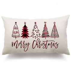 a white pillow with red and black christmas trees printed on the front, along with merry christmas lettering